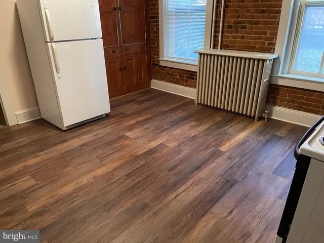 an empty room with wooden floor and door