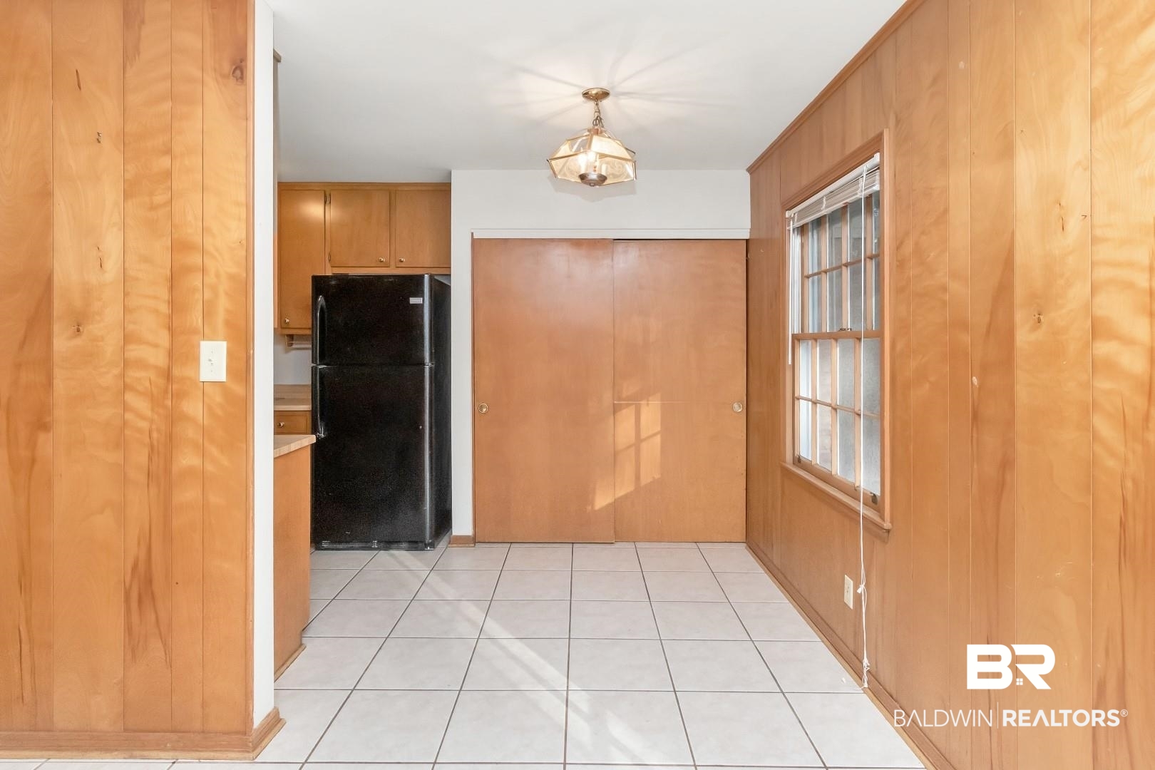 5517 Vanderbilt Drive Mobile, AL 36608 - Photo 15 of 33 Interior space with wood walls and light tile patterned floors