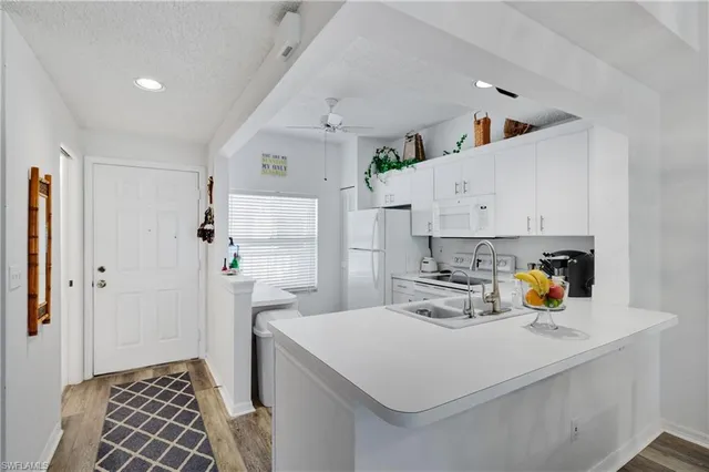 a kitchen with a sink and refrigerator