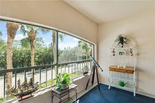 a view of a porch with furniture and a window