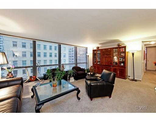 910 North Lake Shore Drive, Unit 718 Chicago, IL 60611 - Photo 4 of 10 a living room with furniture a lamp and a floor to ceiling window