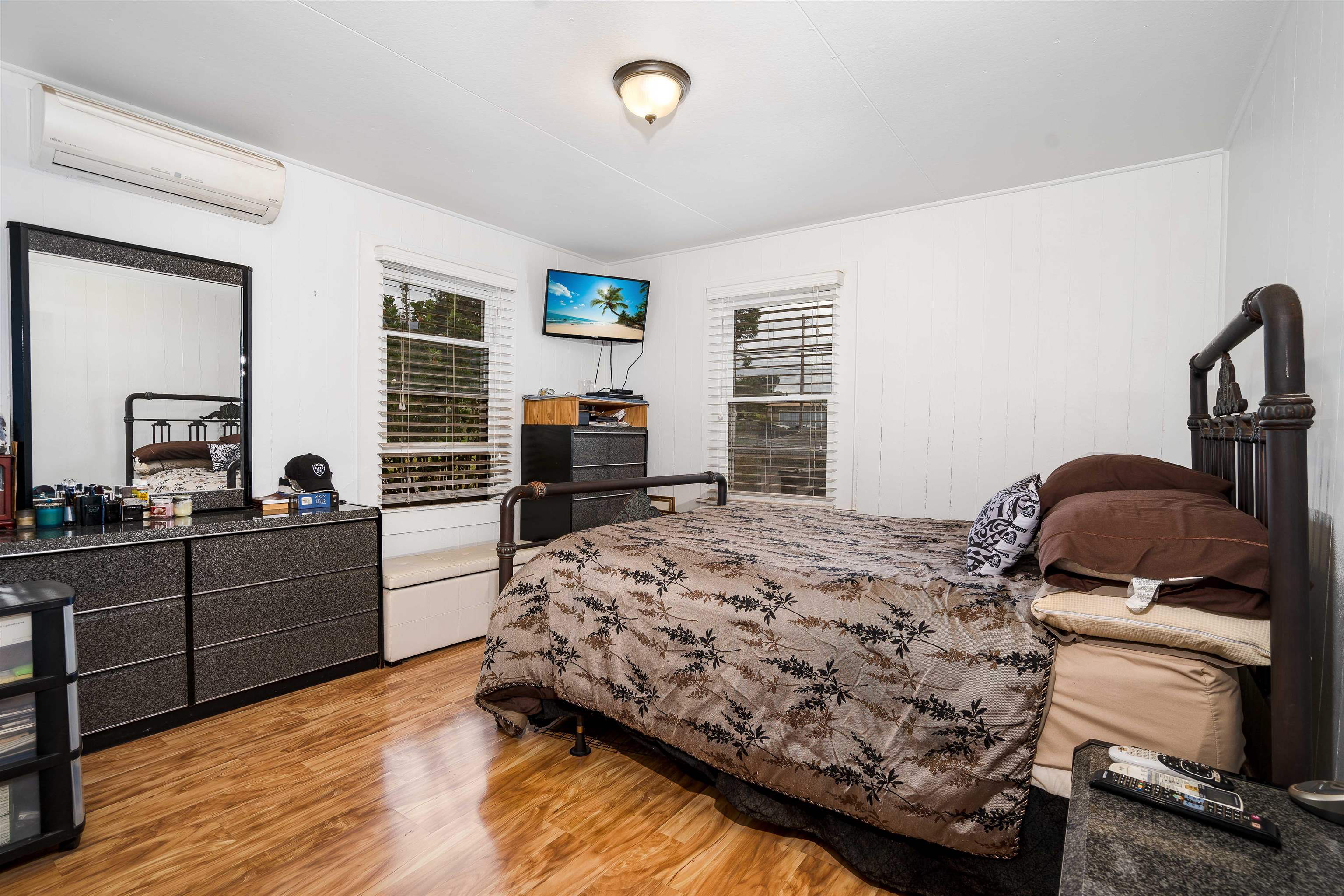 5340 Lower Kula Road Kula, HI 96790 - Photo 11 of 29 a bedroom with a bed and wooden floor