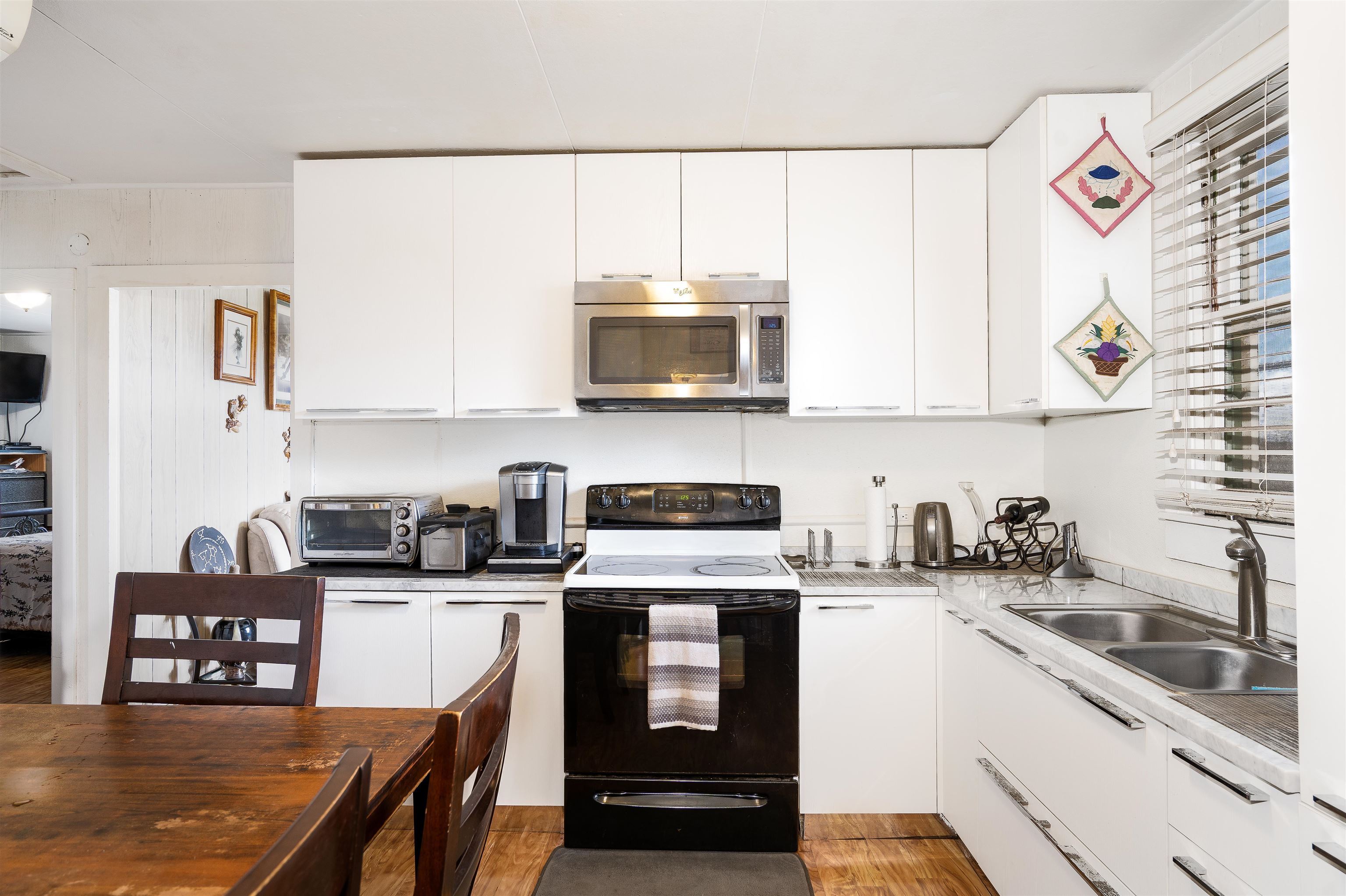 5340 Lower Kula Road Kula, HI 96790 - Photo 4 of 29 a kitchen with stainless steel appliances granite countertop a stove a sink a microwave a refrigerator and cabinets