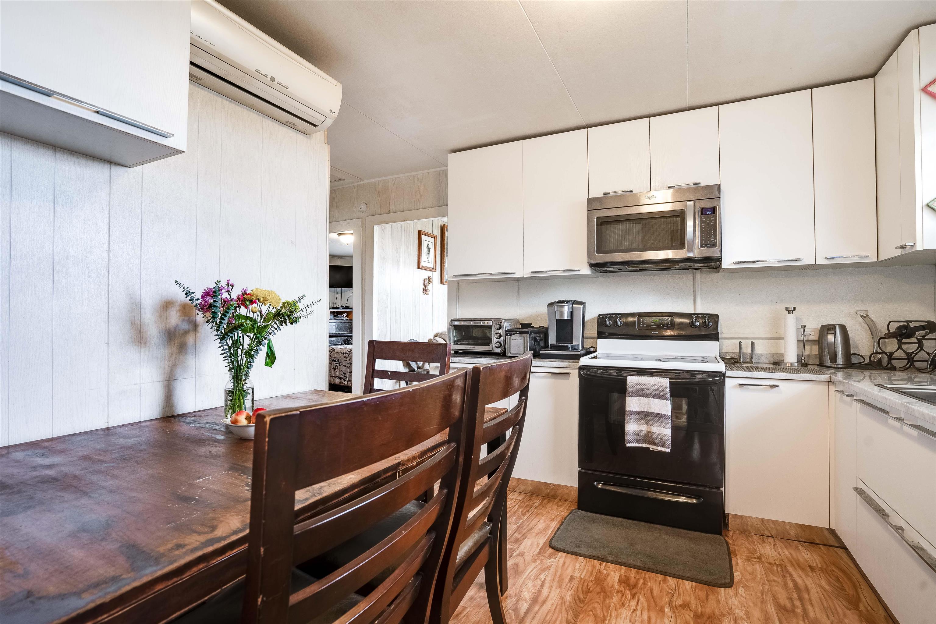 5340 Lower Kula Road Kula, HI 96790 - Photo 8 of 29 a kitchen with stainless steel appliances a sink a stove a microwave and cabinets