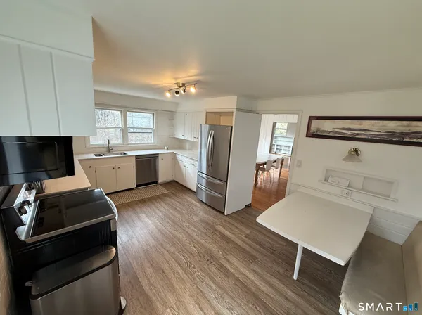 a kitchen with a sink appliances and cabinets