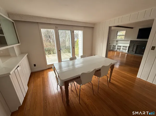 a view of walk in closet with wooden floor