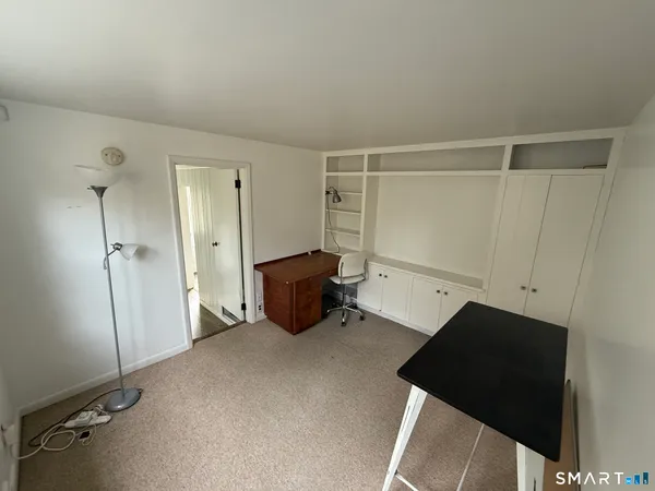 a view of a living room with wooden floor and a ceiling fan