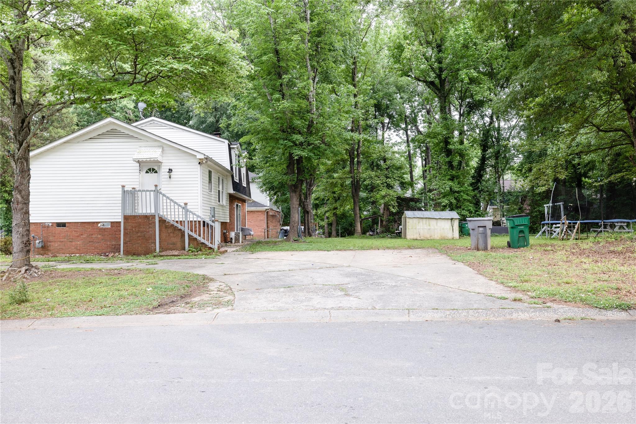 2545 Cedarwild Road Charlotte, NC 28212 - Photo 24 of 25 a front view of a house with a yard and a garage