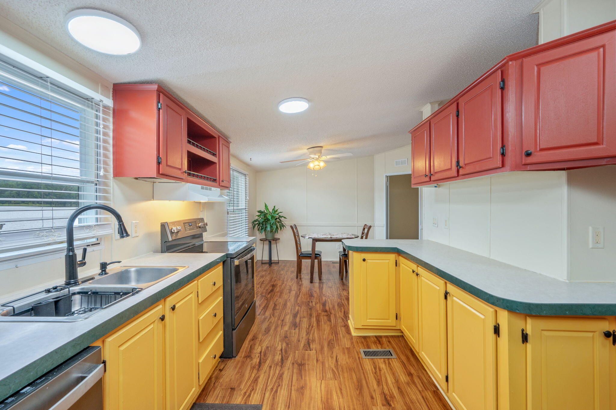 1314 Riddle Drive Westville, FL 32464 - Photo 13 of 35 a kitchen with stainless steel appliances granite countertop a sink a stove cabinets counter space and a window