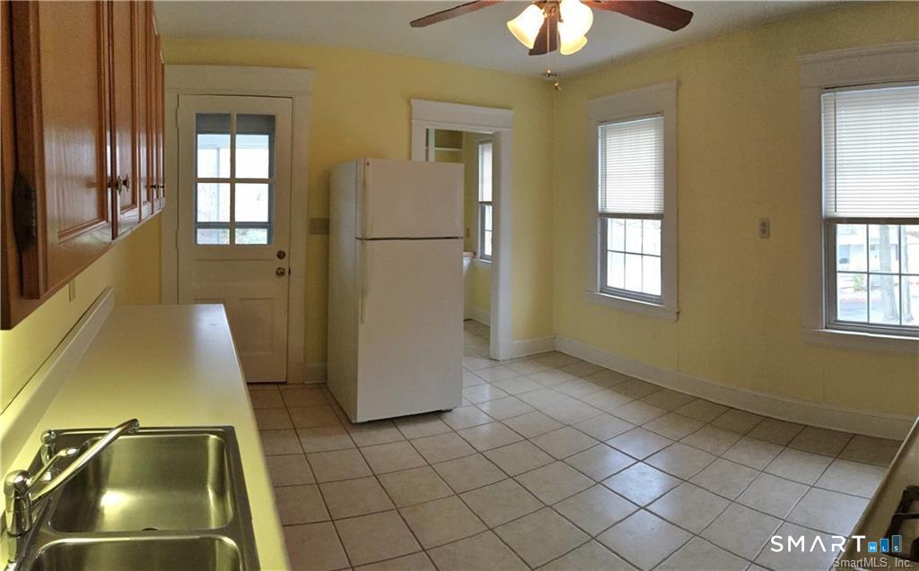 28 Grove Street Thomaston, CT 06787 - Photo 3 of 10 a view of an empty room with window and chandelier