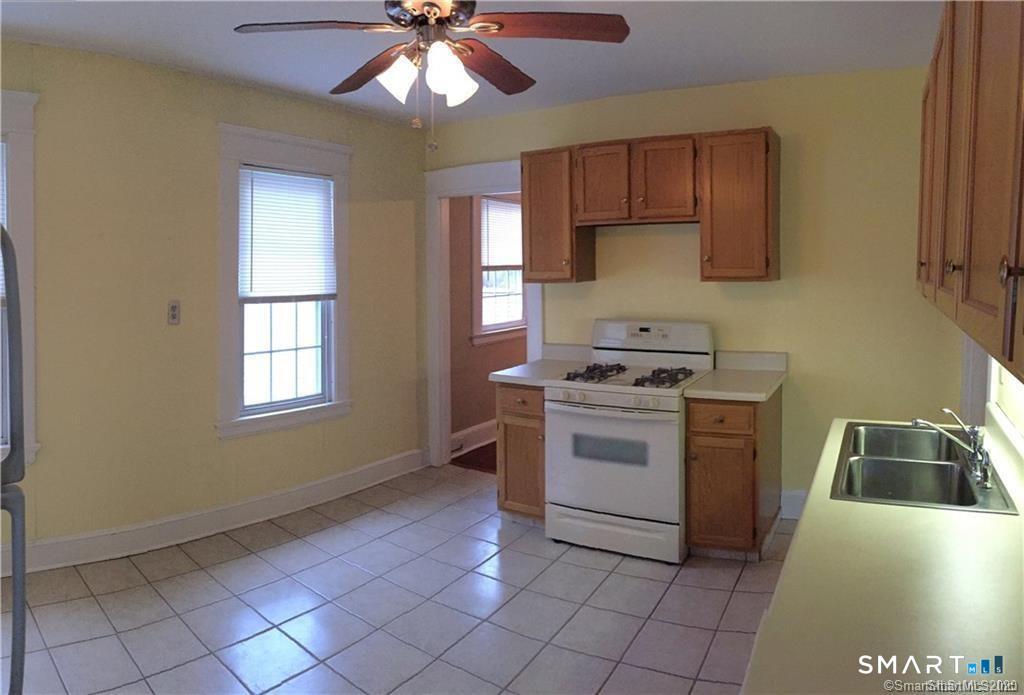 28 Grove Street Thomaston, CT 06787 - Photo 7 of 10 a kitchen with a sink cabinets and window