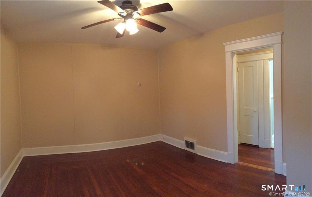 28 Grove Street Thomaston, CT 06787 - Photo 9 of 10 a view of an empty room with wooden floor