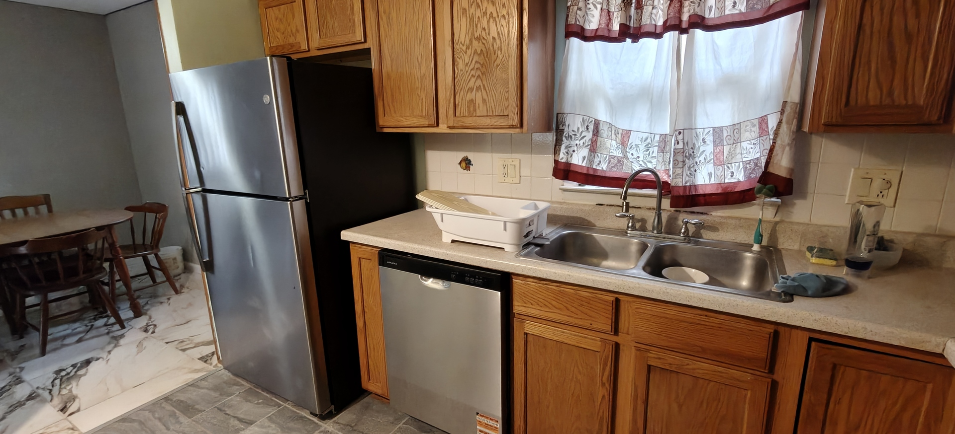 4515 Raven Street Rockford, IL 61107 - Photo 10 of 22 a kitchen with stainless steel appliances a sink cabinets and a window