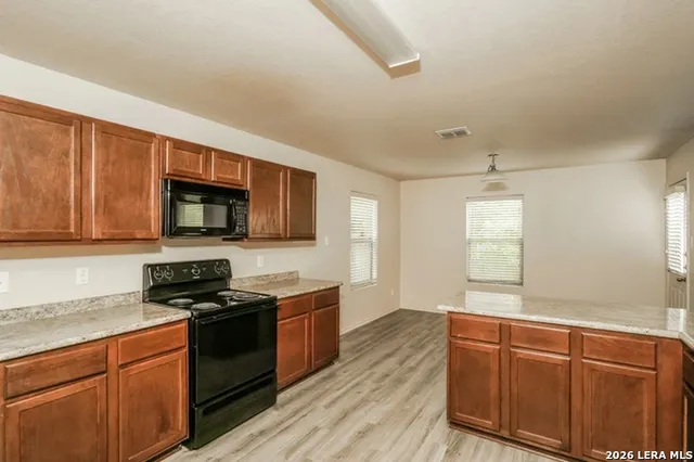 a kitchen with a stove and a refrigerator