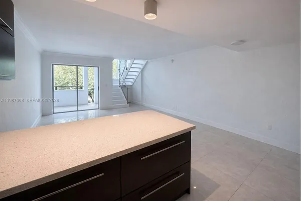 a kitchen with stainless steel appliances granite countertop a stove a refrigerator and a microwave