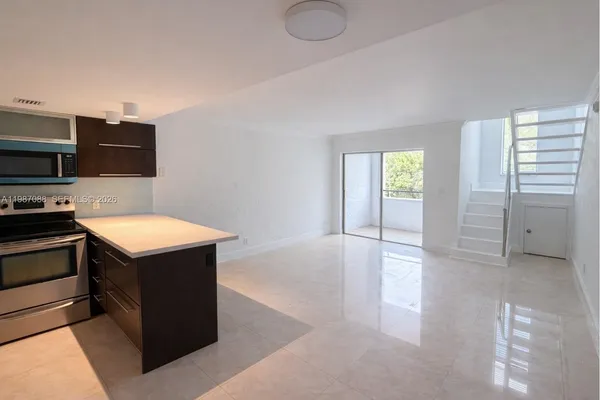 a kitchen with stainless steel appliances a refrigerator and a microwave
