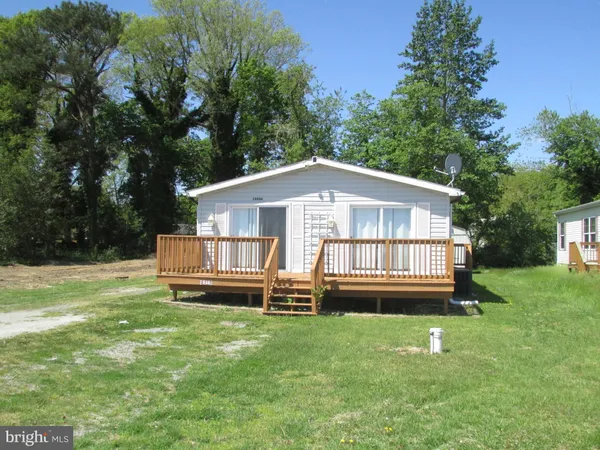 a front view of a house with a yard table and chairs