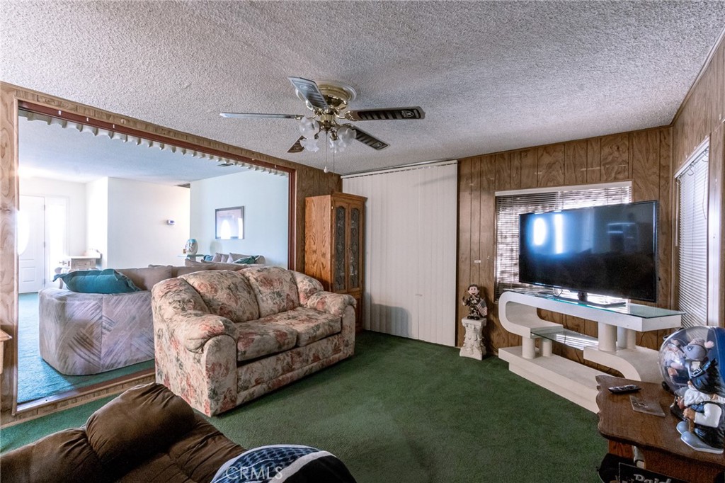 26218 McCall Boulevard Menifee, CA 92586 - Photo 12 of 33 a living room with furniture and a flat screen tv