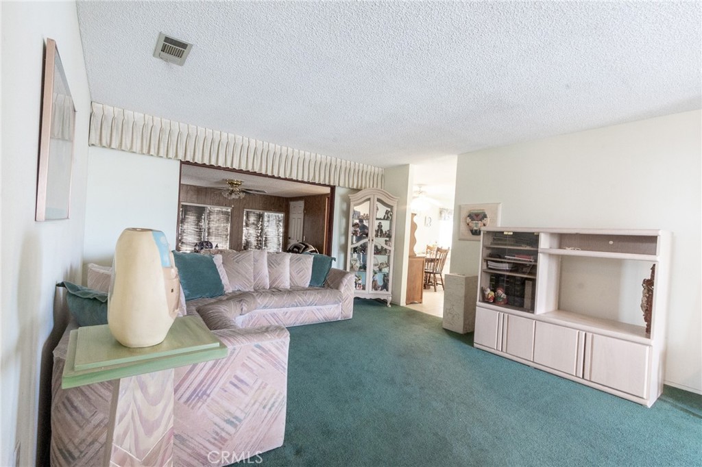 26218 McCall Boulevard Menifee, CA 92586 - Photo 13 of 33 a living room with furniture and a fireplace