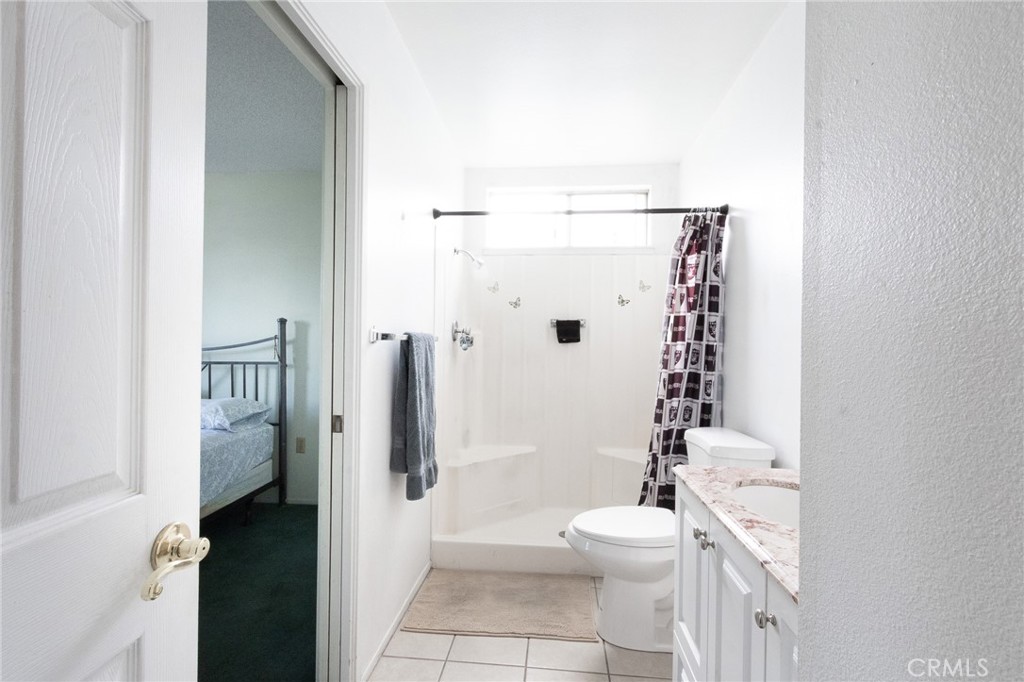 26218 McCall Boulevard Menifee, CA 92586 - Photo 17 of 33 a bathroom with a toilet a sink and shower