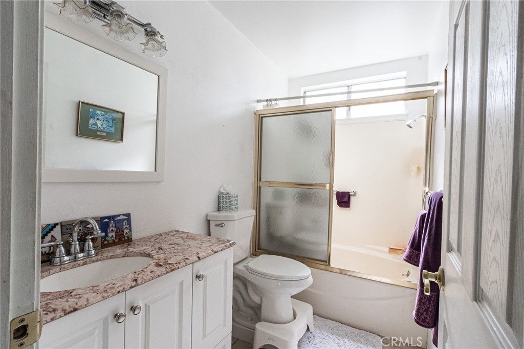 26218 McCall Boulevard Menifee, CA 92586 - Photo 23 of 33 a bathroom with a granite countertop sink toilet and shower