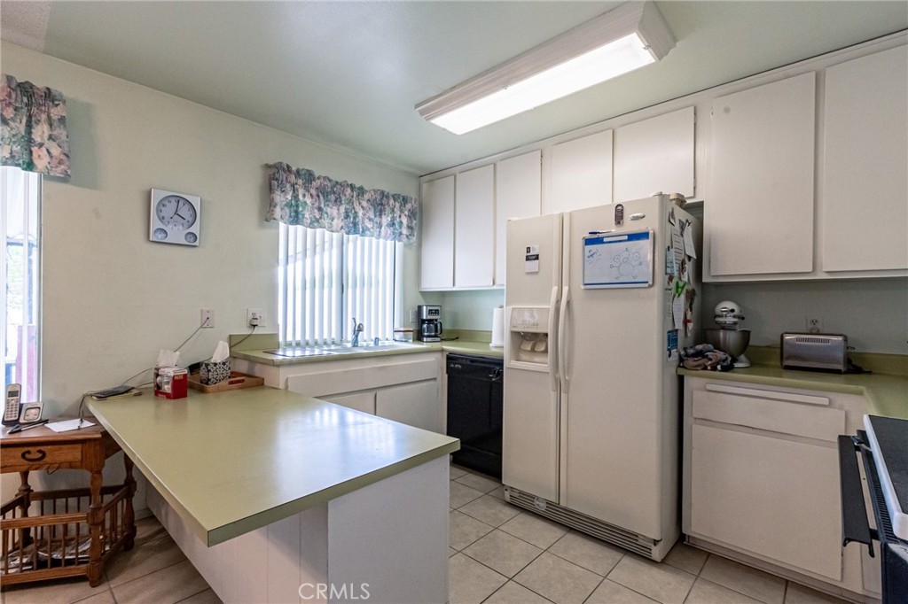 26218 McCall Boulevard Menifee, CA 92586 - Photo 28 of 33 a kitchen with a stove a refrigerator and a sink