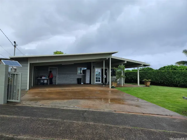 a view of a car park in front of a house