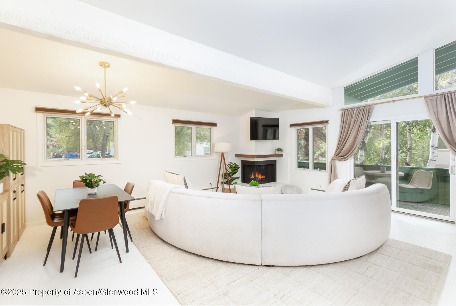 a living room with furniture a table and a large window