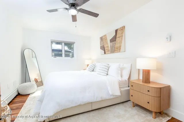 a bedroom with bed and window