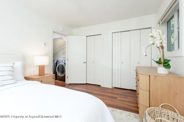 a bedroom with a bed dresser and a mirror