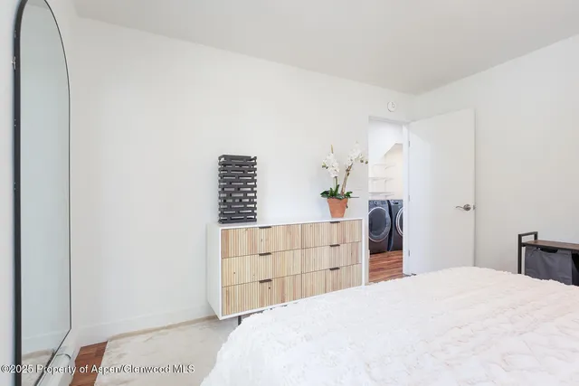 a bedroom with a bed and cabinets