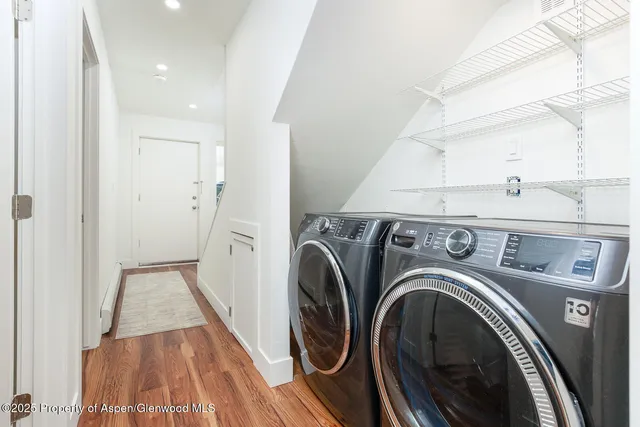 a view of a storage & utility room with dryer and washer