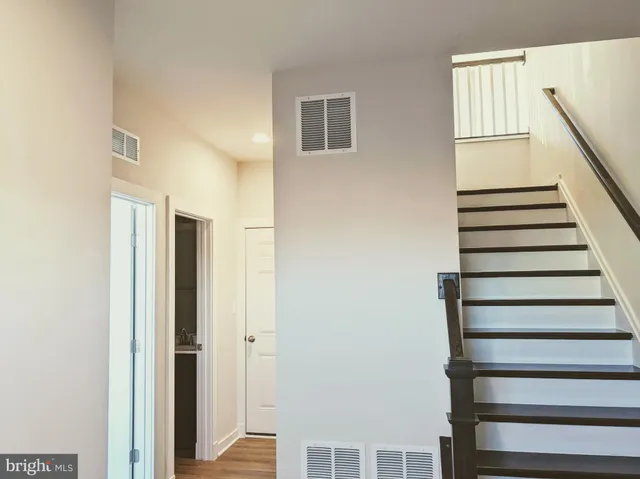 a view of entryway with wooden floor and stairs