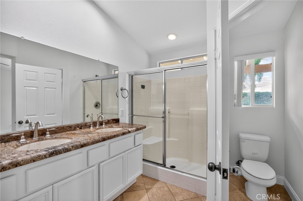 80601 Declaration Avenue Indio, CA 92201 - Photo 13 of 15 a bathroom with a granite countertop sink toilet and shower