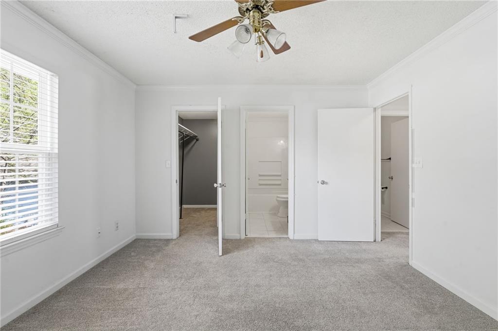 393 Promenade Court Marietta, GA 30064 - Photo 25 of 42 a view of a room with a ceiling fan and window