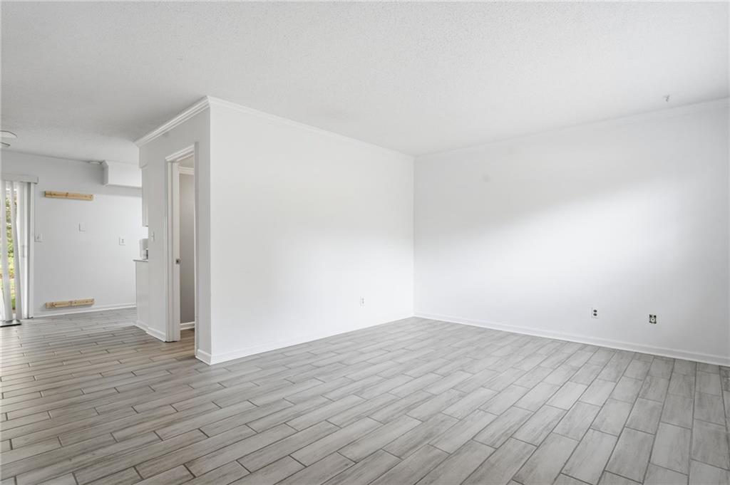 393 Promenade Court Marietta, GA 30064 - Photo 3 of 42 a view of an empty room with wooden floor