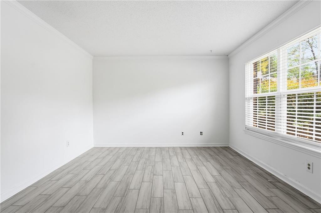 393 Promenade Court Marietta, GA 30064 - Photo 4 of 42 an empty room with wooden floor and windows