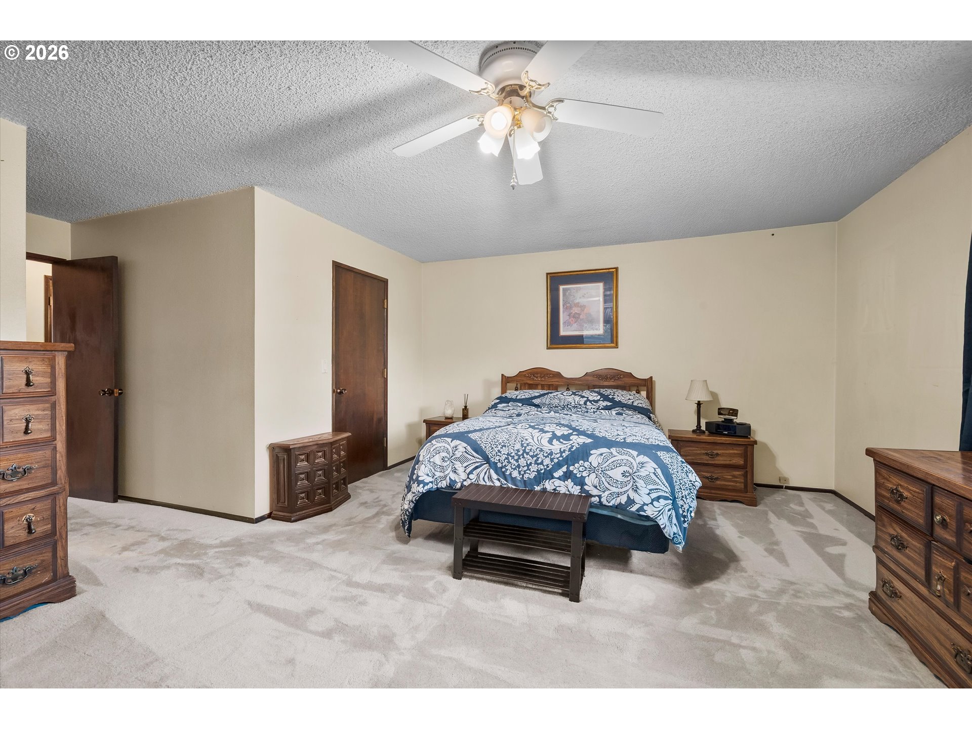 2407 Northeast Libby Place Bend, OR 97701 - Photo 15 of 23 a bedroom with a bed a chandelier and a dresser