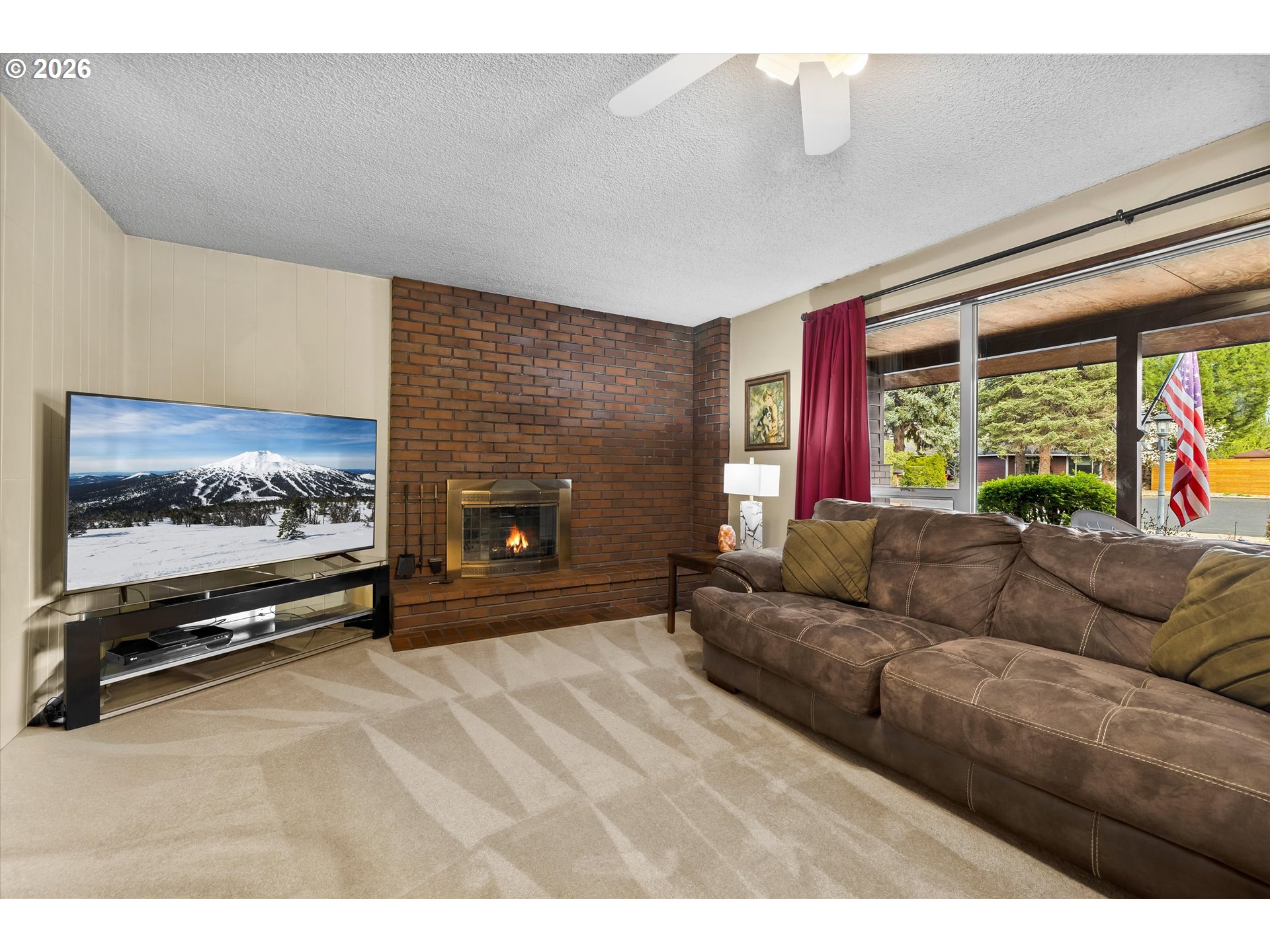 2407 Northeast Libby Place Bend, OR 97701 - Photo 2 of 23 a living room with furniture a flat screen tv and a fireplace
