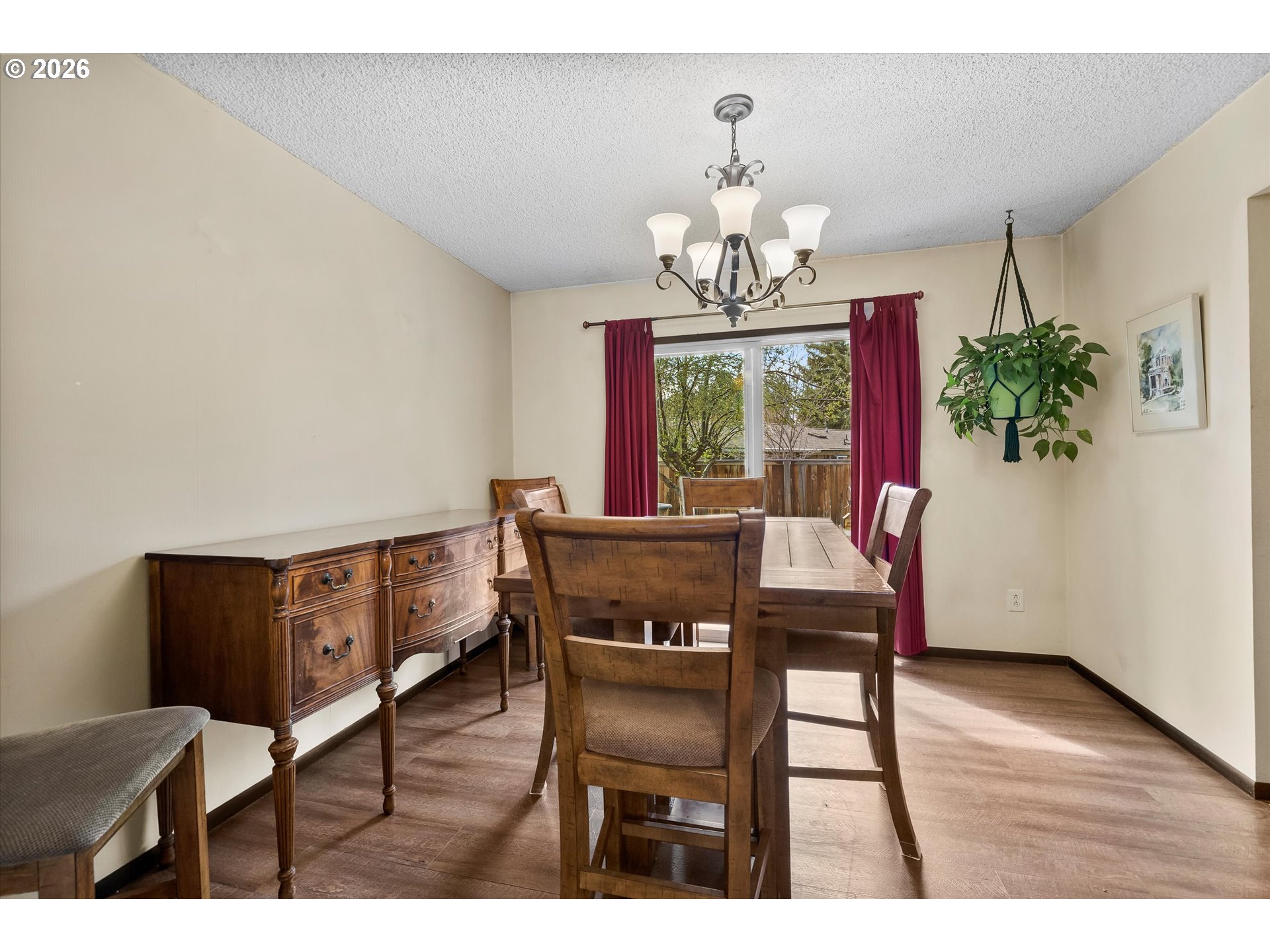 2407 Northeast Libby Place Bend, OR 97701 - Photo 4 of 23 a view of a dining room with furniture a chandelier and wooden floor
