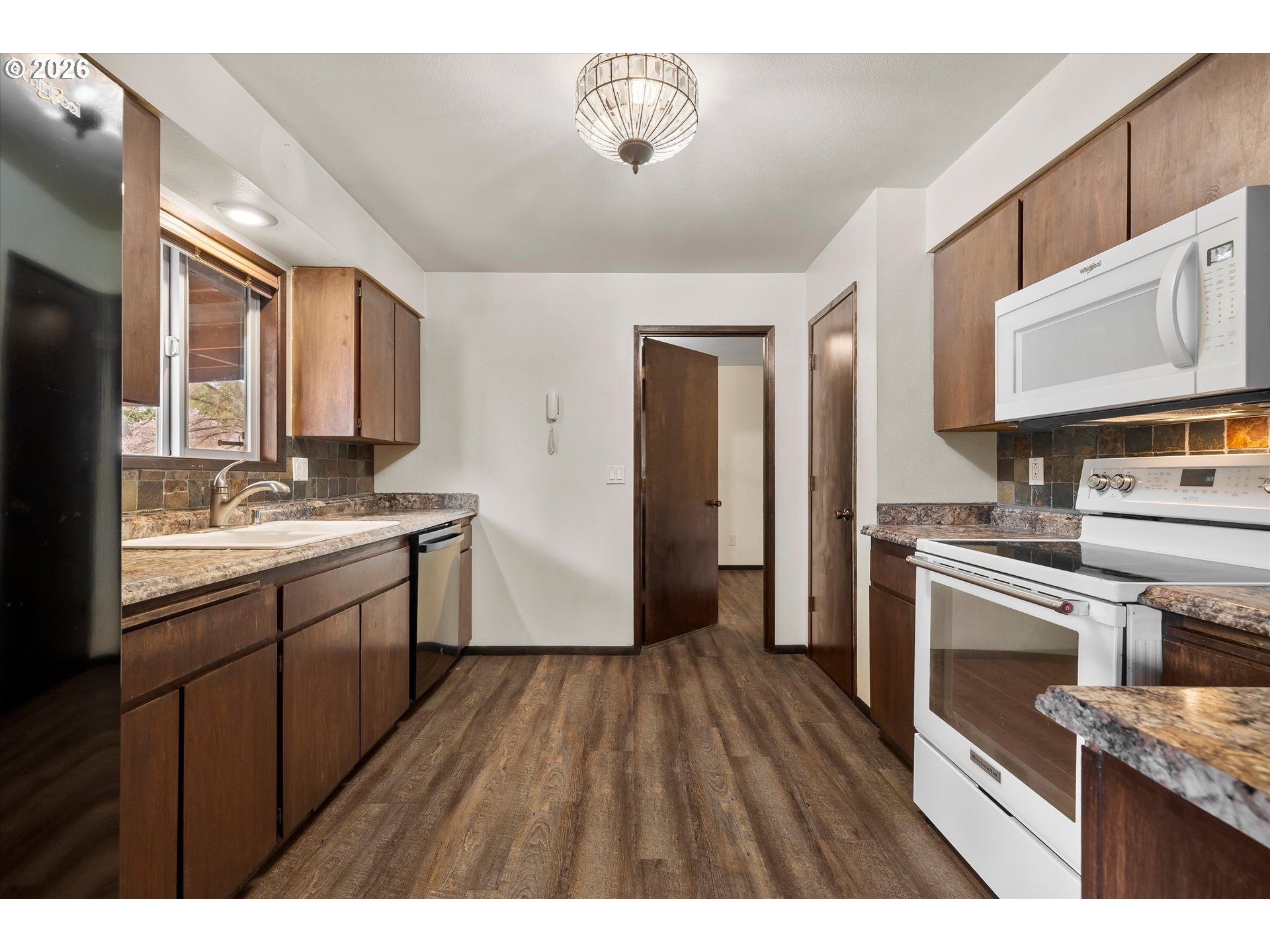 2407 Northeast Libby Place Bend, OR 97701 - Photo 6 of 23 a kitchen with a sink stove and refrigerator
