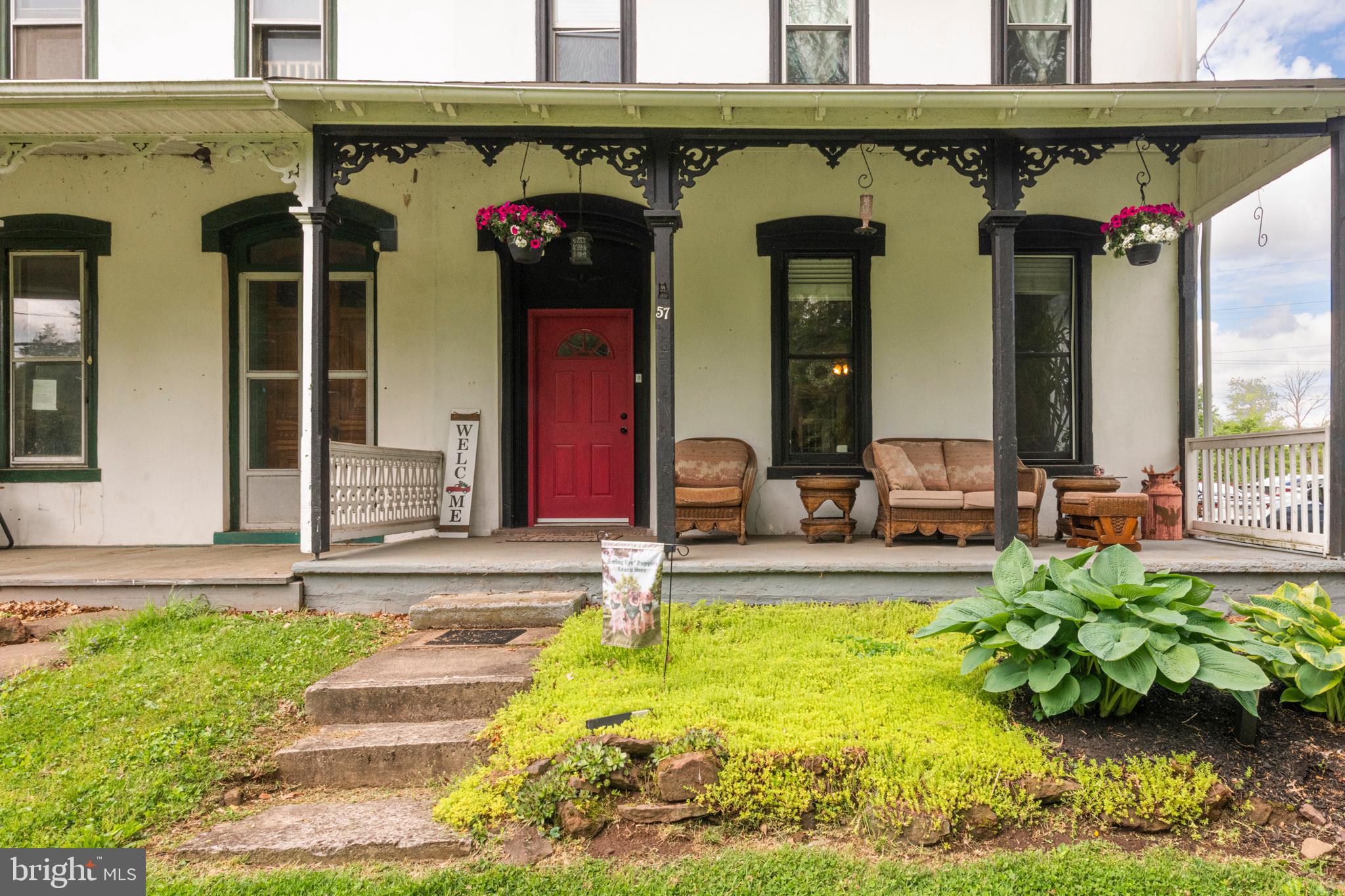 57 Longview Road Royersford, PA 19468 - Photo 4 of 53 a view of a house with potted plants and a wooden bench