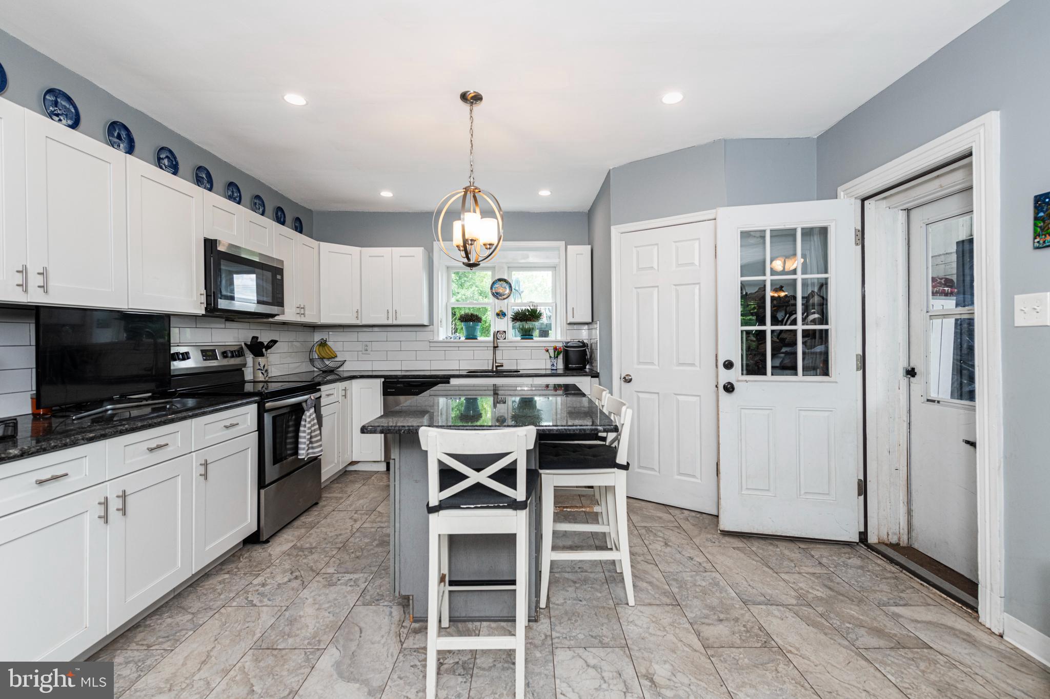 57 Longview Road Royersford, PA 19468 - Photo 6 of 53 a kitchen with stainless steel appliances kitchen island granite countertop a stove a sink and a refrigerator