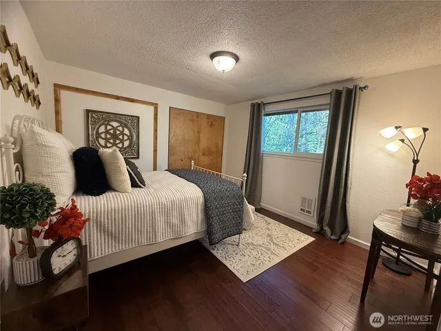 a bedroom with a bed and a mirror