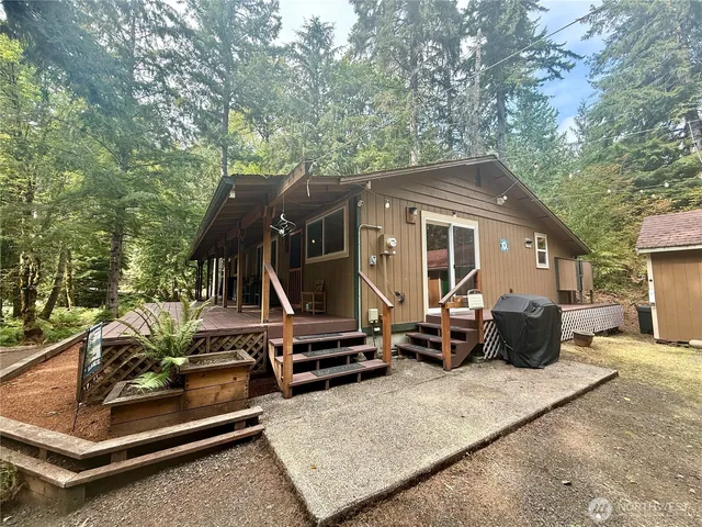 a view of a house with backyard and sitting area