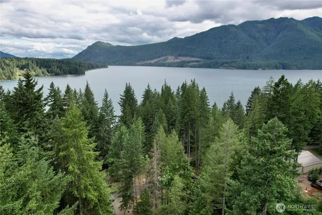 a living room with furniture and a dining table with wooden floor