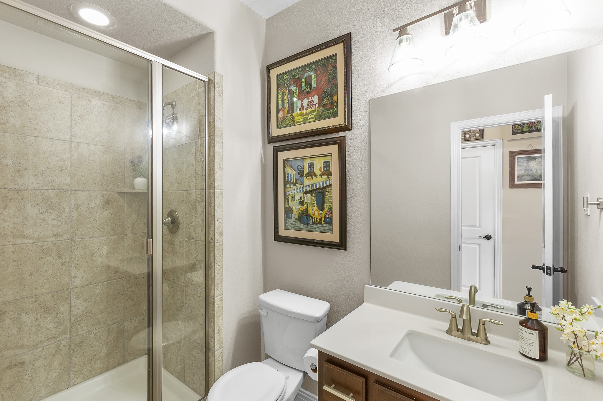 7613 Turnback Ledge Trail Lago Vista, TX 78645 - Photo 13 of 40 a bathroom with a toilet a sink and mirror