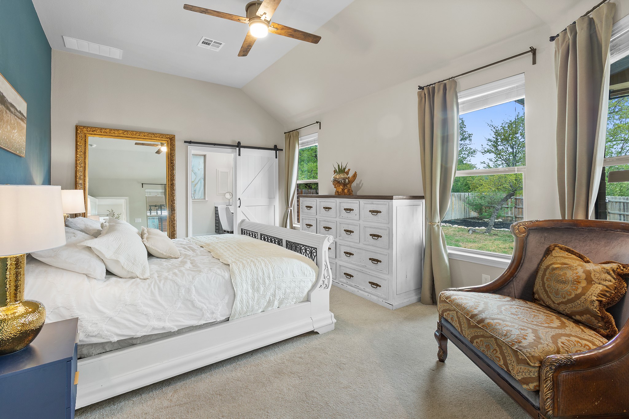 7613 Turnback Ledge Trail Lago Vista, TX 78645 - Photo 19 of 40 a bedroom with a bed couch and windows