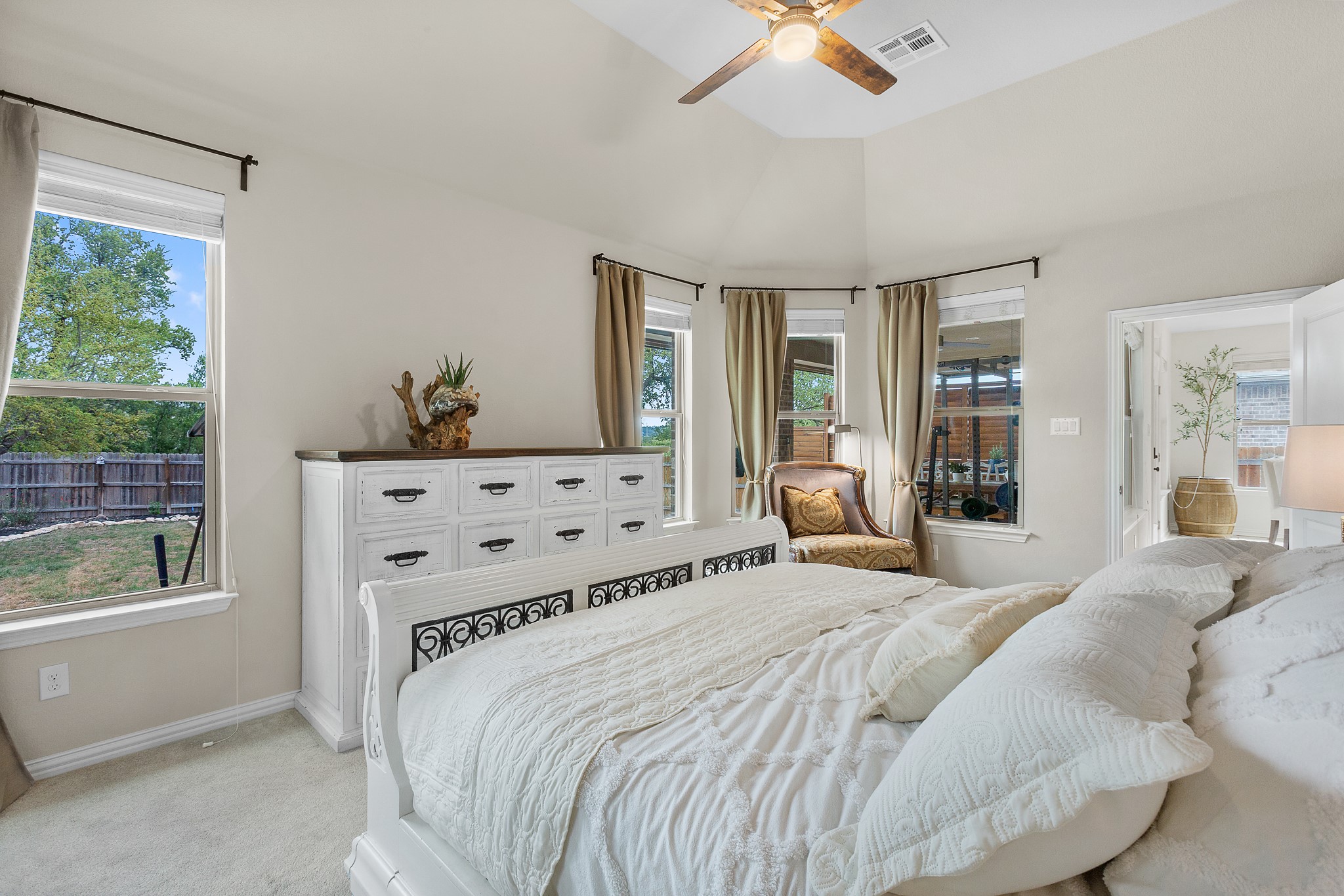 7613 Turnback Ledge Trail Lago Vista, TX 78645 - Photo 20 of 40 a bedroom with a large bed and a window