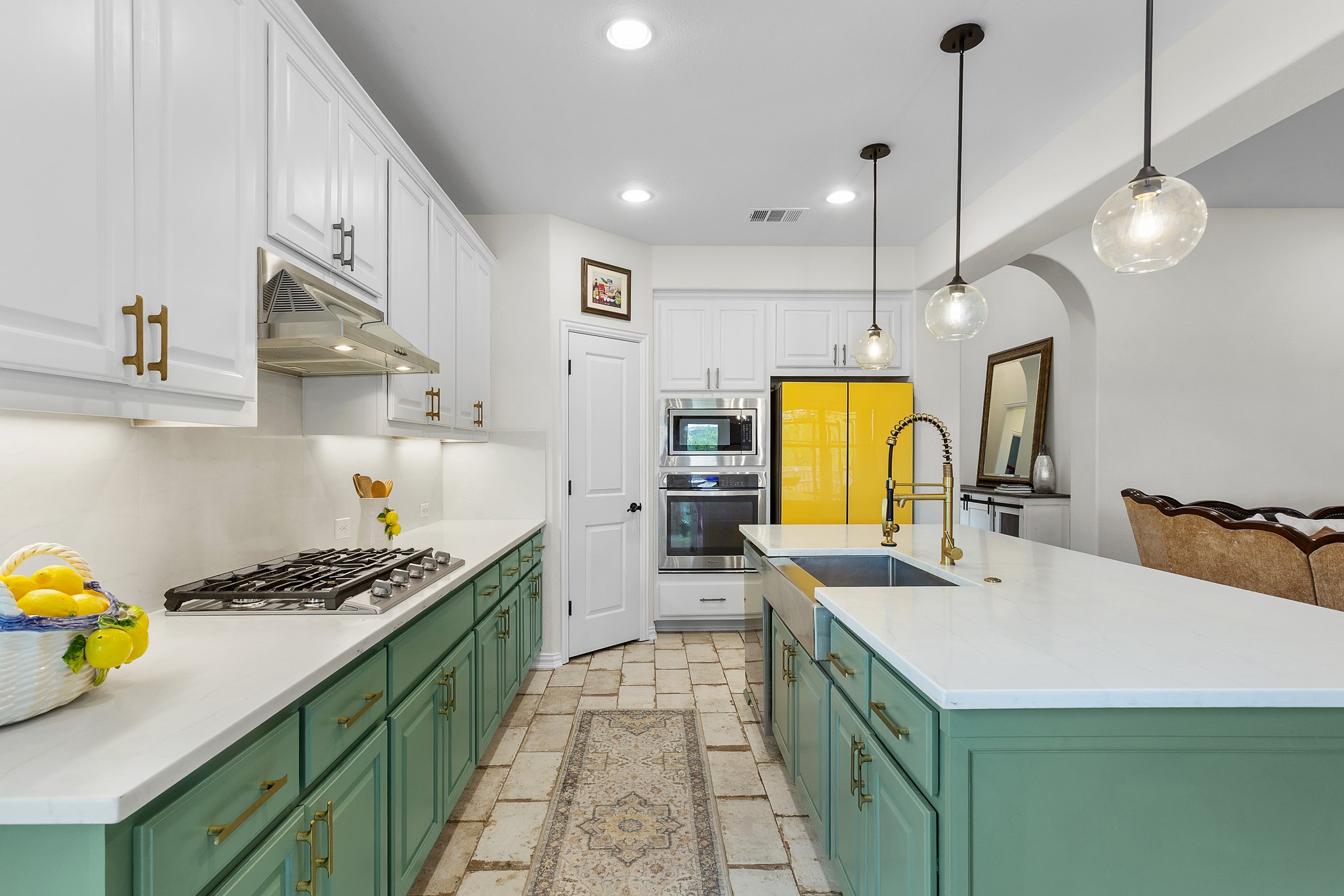 7613 Turnback Ledge Trail Lago Vista, TX 78645 - Photo 2 of 40 a kitchen with a sink a stove and wooden cabinets